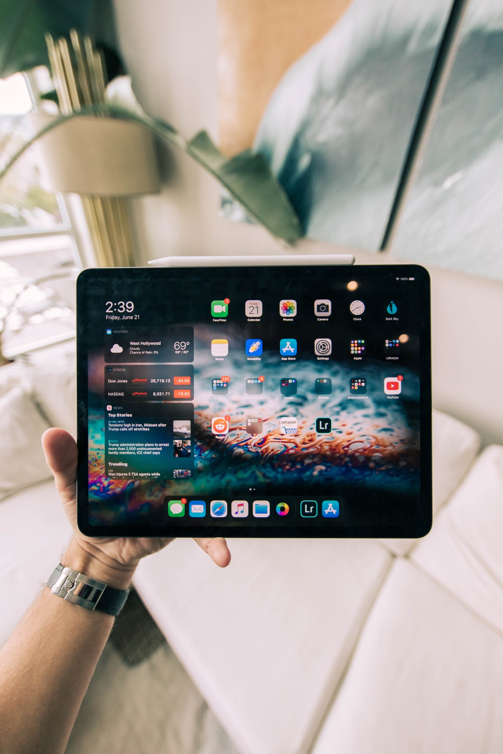 Man Holding iPad Against Aesthetic Background
