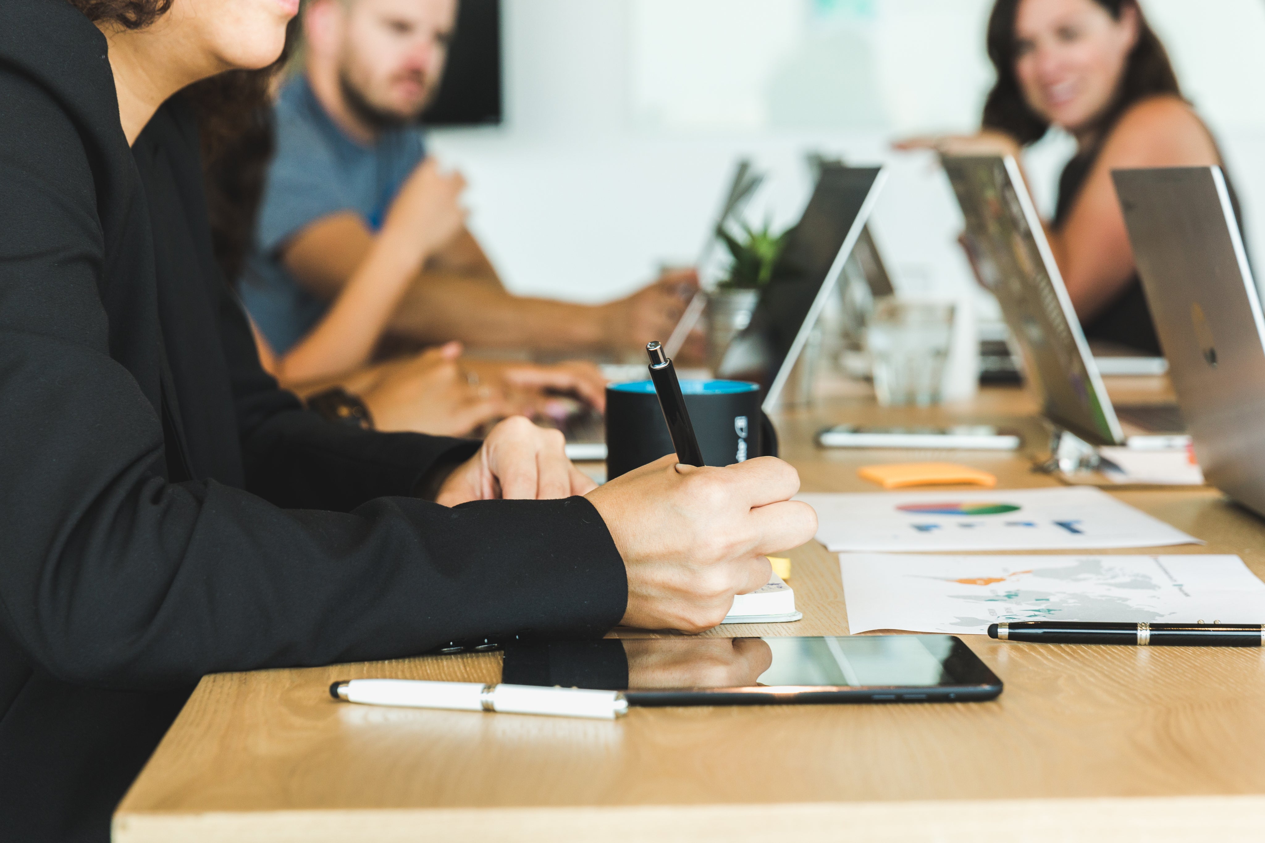 Woman Taking Noted During Team Meeting